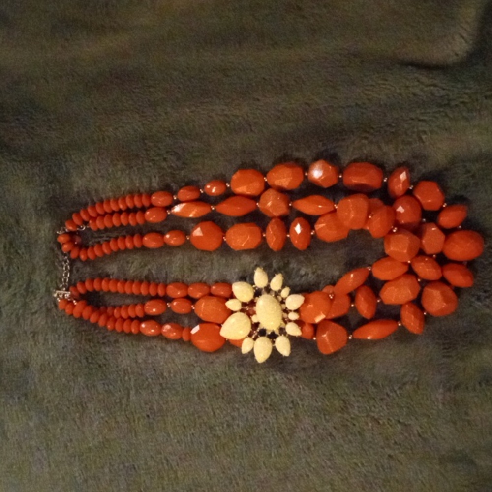 Chunky Orange Necklace with Cream flower attachment.